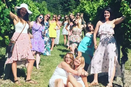 Girls posing in a vineyard on a Summerland wine tour
